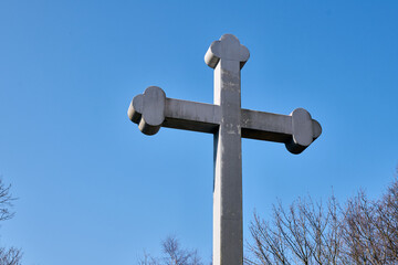 Large stone cross against clear blue sky
