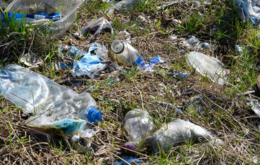 Scattered plastic waste polluting nature. Environmental damage from bottles, bags, and packaging...