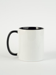 Two-tone 11oz mug on isolated background. Mug with black handle and inner part.