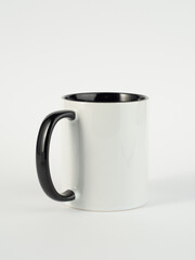 Two-tone 11oz mug on isolated background. Mug with black handle and inner part.