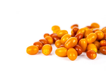 Top view of  fresh yellow and orange cherry tomatoes scattered on white background.   Isolated on clean white backdrop. Food, health, and organic nutrition concepts. Copy space