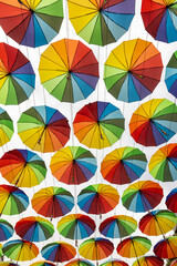 Colorful Umbrellas Hanging Overhead Against the Sky