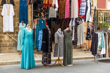 Fototapeta premium Tel Aviv-Jaffa, Israel, 9 April 2025, A colorful display of women's clothing for sale outside a shop in the old Jaffa