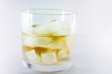 Whisky Close up with ice dark strong shadows light with a white background