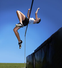 Woman, high jump and athlete leap for sport training outdoor for competition, endurance or...