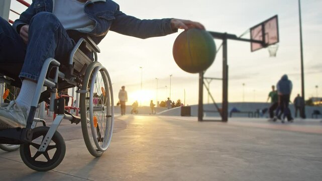 A physically challenged athlete is engaged in a game of street basketball, demonstrating exceptional ball handling skills. Slow motion