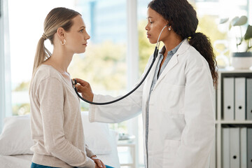 Doctor listening to patient breathing, heartbeat and lungs for respiratory test or consult in a...