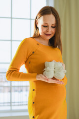 Pregnancy motherhood people expectation future. Pregnant woman with big belly holding newborn baby...