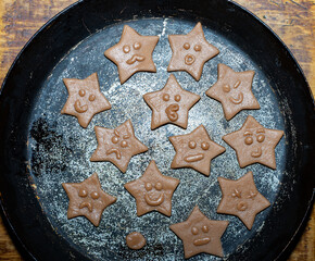 Cookie baking with star-shaped faces in a rustic kitchen setting
