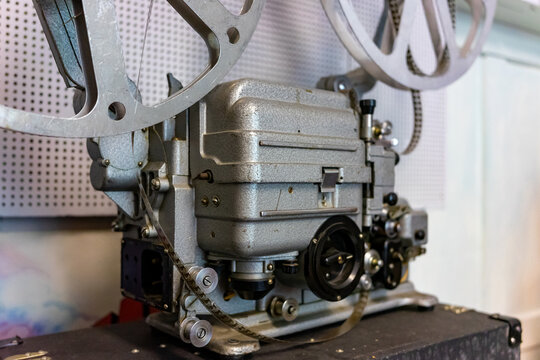 Vintage film projector displayed in a retro movie theater