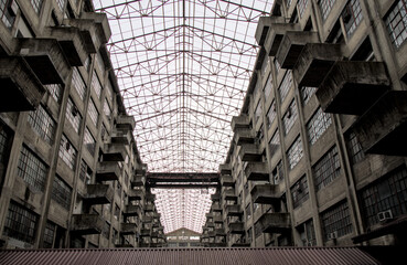 view of abandoned atrium with balconies and train tracks in brooklyn army terminal building (bleak...