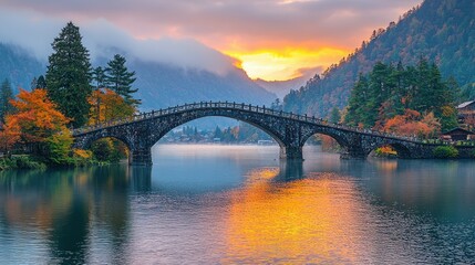 Obraz premium Serene Autumn Sunrise over a Stone Arch Bridge