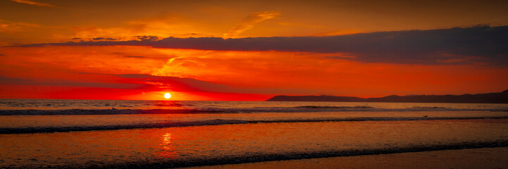 Panorama of Sunset at Morro Bay California. The sun cast a warm, golden hue across the landscape. Morro Bay came alive with the breathtaking spectacle of a beautiful sunset