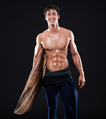 Studio, surfboard and portrait of happy male surfer, wetsuit and athlete isolated on black...
