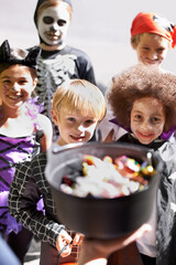 Halloween, candy and children on porch of home for trick or treat tradition in neighborhood together. Smile, kids and group of friends collecting sweets for autumn holiday celebration from above