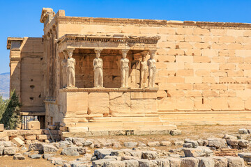Fototapeta premium A building with statues of women on the front, Acropolis in Athens