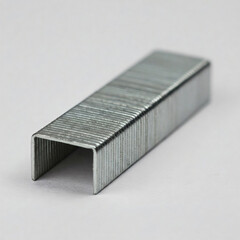 Metal staples on a white background. Shallow depth of field.