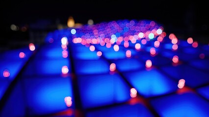 Pink and white bokeh lights illuminating blue squares at night