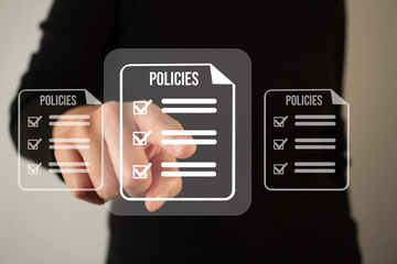 Close-up of a business person touching a virtual screen with document and checklist icons on it. Approve policies