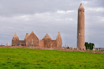 A tall tower stands in front of a church