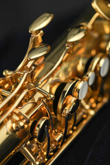 Jazz. One beautiful saxophone on black background, closeup