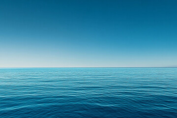 Obraz premium Calm turquoise waters reflect a clear sky during midday in a serene coastal location