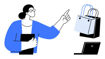 Woman in blue jacket holding document, pointing towards shopping bags and laptop. Ideal for e-commerce, digital marketing, online shopping, business planning, consumer behavior, retail strategy