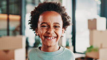 Excited, moving day and portrait of child in home with boxes smile for new house, apartment or...