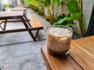 Latte coffee. Fresh drink Iced coffee latte in glass cup on cafe table. Coffee milk. Cold summer...