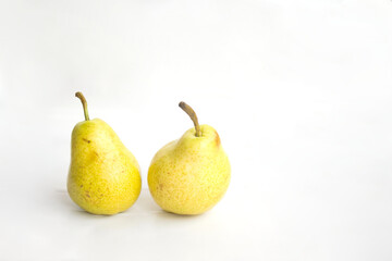 Close-up photo of two pears against a white background. Product and food photography