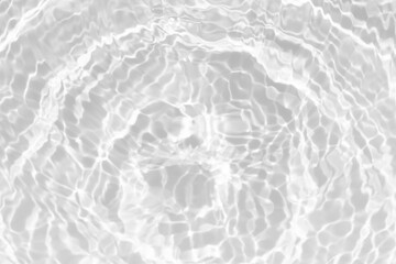 White water with ripples on the surface. Defocus blurred transparent white colored clear calm water surface texture with splashes and bubbles. Water waves with shining pattern texture background.
