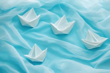 Floating paper boats on a pale blue fabric sea create a tranquil ambiance of poetic minimalism in a serene setting