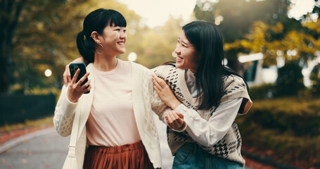 Cellphone, laughing and girl friends in city reading online blog for celebrity gossip together....