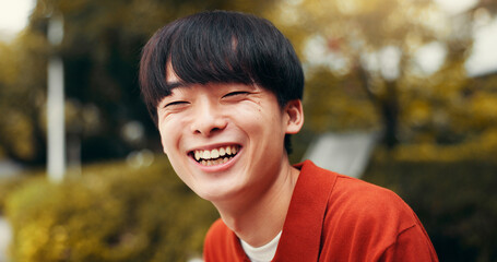 Man, portrait and outdoor Japan for laughing, happy tourist and relax on bench in nature for peace. Male person, travel and journey to holiday destination for joke, funny humor and weekend for break