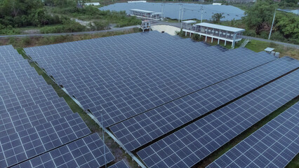 multiple solar panels installed on the rooftop of a building. The solar panels are arranged in neat rows and columns, with clear separations between each panel. 