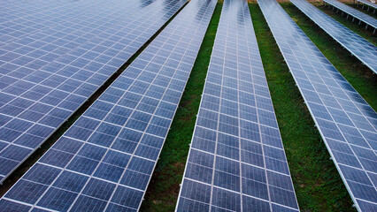 multiple solar panels installed on the rooftop of a building. The solar panels are arranged in neat rows and columns, with clear separations between each panel. 