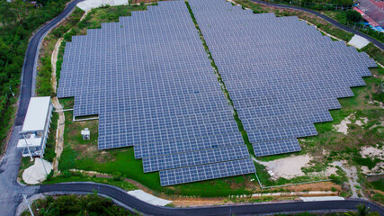 multiple solar panels installed on the rooftop of a building. The solar panels are arranged in neat rows and columns, with clear separations between each panel. 