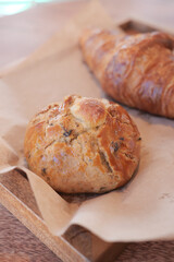 Freshly baked bread rolls displayed on a wooden tray