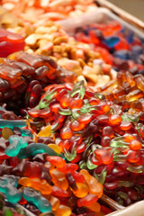 Colorful display of gummy candies at a market stall in autumn