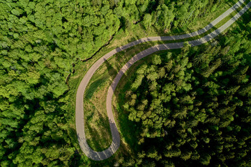 Sharp turn on forest track, roller ski track in wilderness, aerial view
