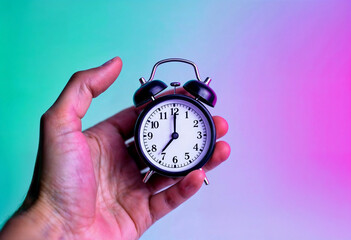 hand holding alarm clock