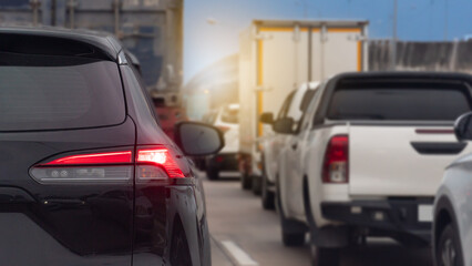 Rear side of cars black color on the road heading towards the goal of the trip. During the daytime...