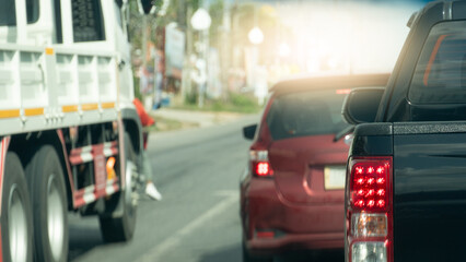 Rear side of pick up car driving on the road. Many car driving on asphalt road. blurred of city side of road at day.