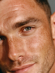 Sun-Kissed Gaze of a Freckled Man with Bright Blue Eyes – Thoughtful Close-Up in Soft Natural Light