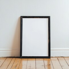 Empty black frame on wooden floor