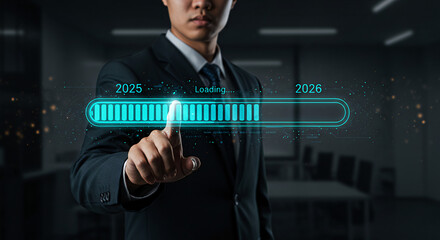 Person pointing to digital loading bar from 2025 to 2026, symbolizing progress, planning, and new business year transition