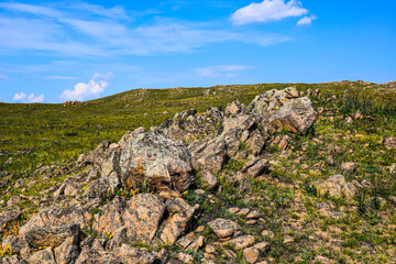 Khakassia. Old stone wall. Mountain landscape with blue sky