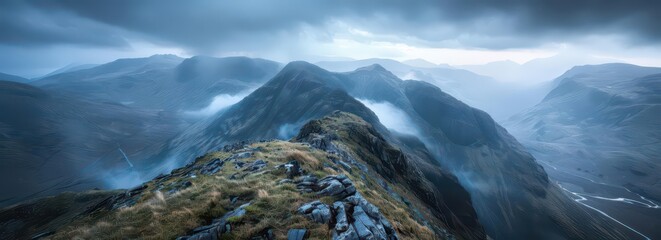 A panoramic view of misty mountains under a cloudy sky, evoking a sense of adventure.