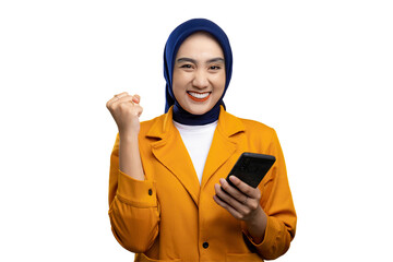 Excited young Asian woman holding mobile phone and gesturing yes, celebrating success, raising clenched fist isolated on transparent background