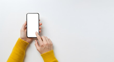 A person is holding a cell phone and pointing at the screen. The phone is white and the person is wearing a yellow sweater. Concept of technology and modernity, as well as a casual, everyday moment.